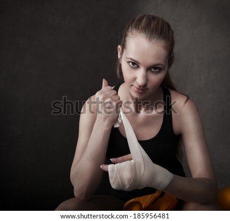 Portrait of a woman boxer wearing white strap on wrist