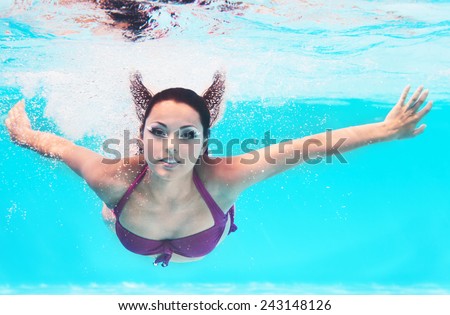 Underwater woman close up portrait in swimming pool