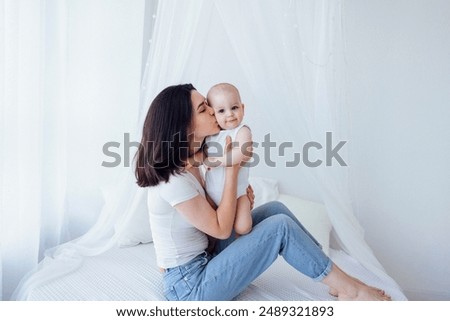 Similar – Image, Stock Photo Adorable mother and child on hand enjoying and laughing in field