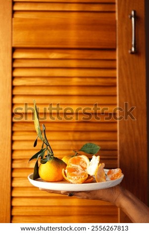 Similar – Foto Bild Orangefarbene Mandarinen in Keramik-Ornamentschale auf Holztisch