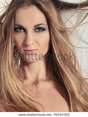 Portrait of young beauty woman with fluttering hair