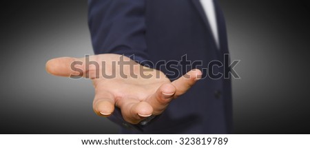 Businessman showing empty hand wearing deep blue suit
