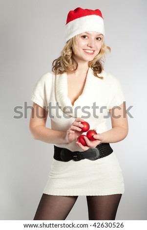 The beautiful young girl in elegant clothes and with New Year\'s attributes