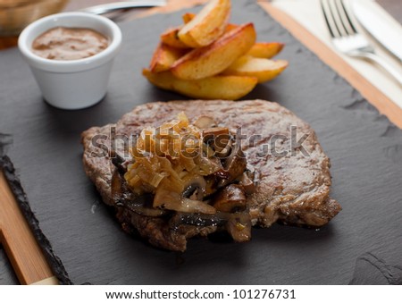 Dry Aged Hereford Rib-Eye Steak with Caramelised onions, Mixed Forrest Mushrooms, Pepper Sauce
