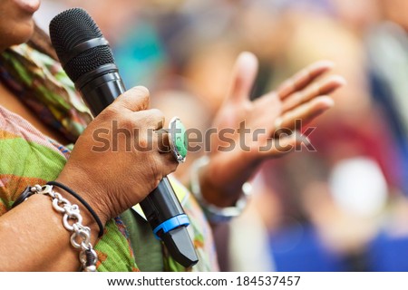 Women Speaking in to the microphone at the conference. Detail