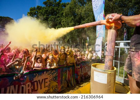 LOUGH CUTRA, GORT, IRELAND - SEPTEMBER 6: Unidentified people having fun get showered in powdered dye during  annual RUN OR DYE, the 5K event, on September 6, 2014 in Lough Cutra, Gort, Ireland.