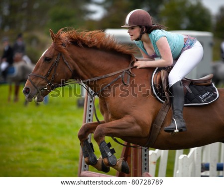 ATHENRY - JULY 3: Young woman Emma Devaney jumping with Horse  at annual Athenry Agricultural Show  on July 3, 2011 in Athenry, Ireland.
