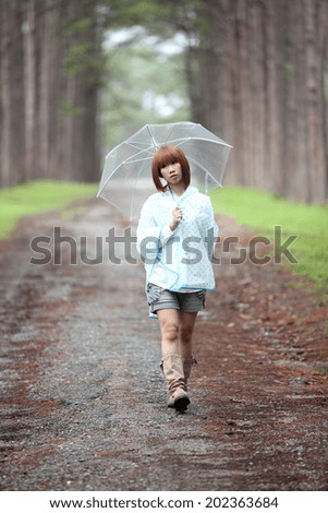 Girl on the rain in pine forest
