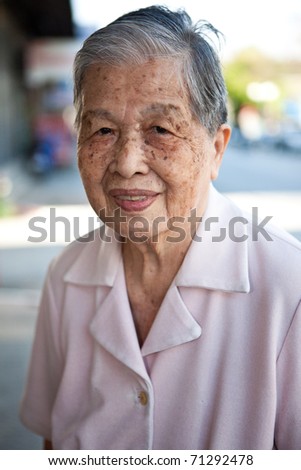 Portrait of an old Asian Chinese woman on home background