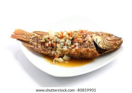 Thai food fried fish with spicy sauce isolated in white background