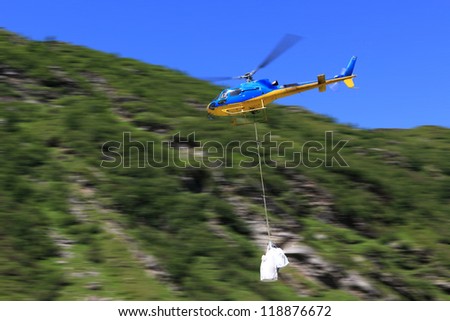 Image, Stock Photo Helicopter with bag for water working in extinguishing a fire.