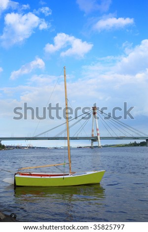 Small sailing boat against guy  bridge. The city of Cherepovets. Russia