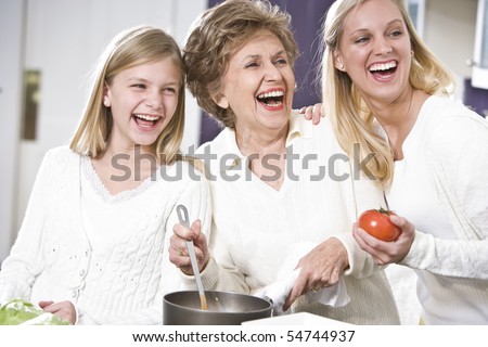 Grandmother with family cooking in kitchen, smiling and laughing together