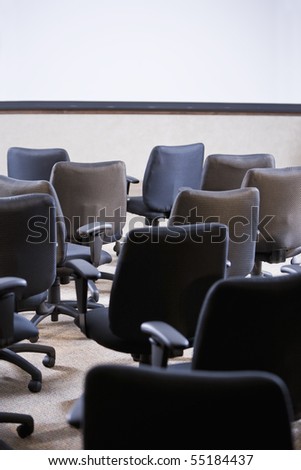 Room full of empty office chairs, rear view