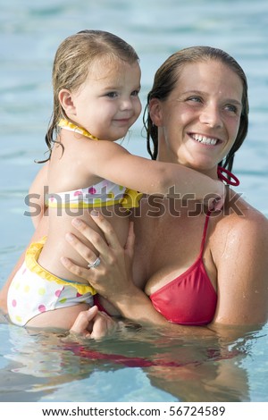 Mother and 2 year old girl in swimming pool