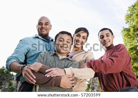 Portrait of Hispanic family with two boys outdoors