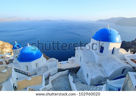 Famous Blue Domes of orthodox churches on the sea background in Santorini island, Greece.