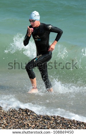 GENEVA, SWITZERLAND - JULY 22 : unidentified female athlete going out of water at the International Geneva Triathlon, on July 22, 2012 in Geneva, Switzerland.