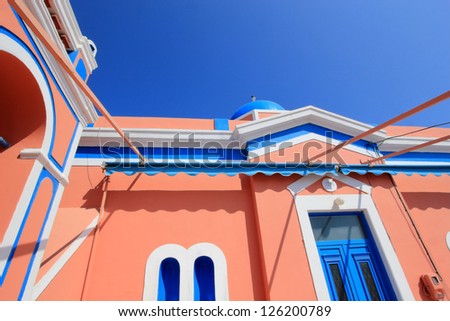 Close up of colorful orthodox church with typical architecture and blue dome in Oia, Santorini island, Greece