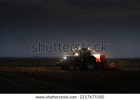 Similar – Image, Stock Photo Farmer on a tractor digs out potatoes from soil. Extract root vegetables to surface. Harvesting potatoes in autumn. Farming and farmland. Agricultural work in the field. Countryside.