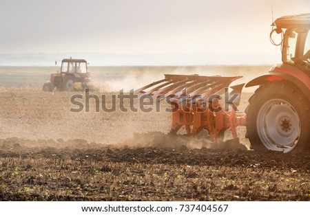Tractor plowing fields  -preparing land for sowing  商業照片 © 