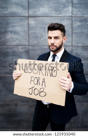 Young business woman holding sign Looking for a job