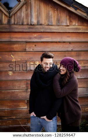 Young cheerful couple in a cabin in a romantic scape.