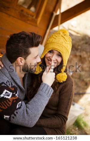 Young couple in a cabin in romantic scape in winter