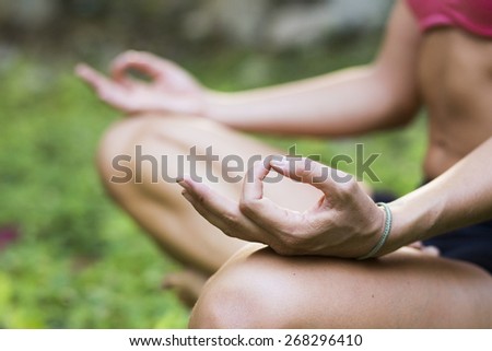 Yoga teacher practicing meditation outdoors