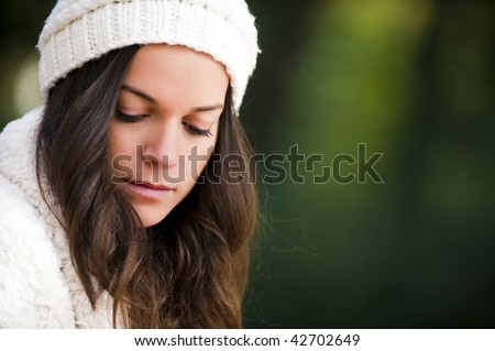 Young beautiful woman looking down with sadness face