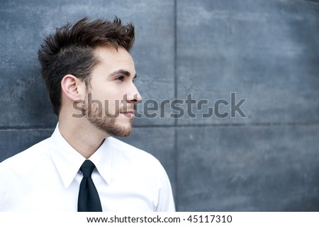 Young handsome man against wall
