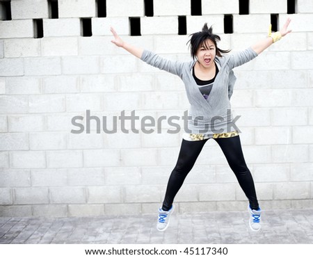 Young asian girl jumping in gym clothes