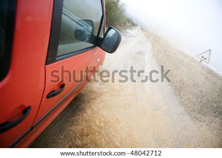 Car splash water at high speed in flood road.