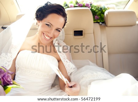 Young beautiful bride in the car