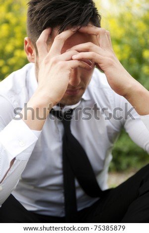 Businessman in depression with hands on forehead