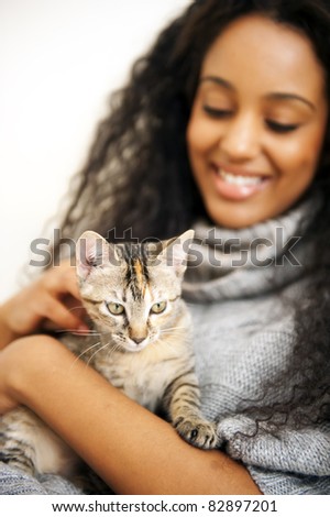 Young african woman with cat indoors
