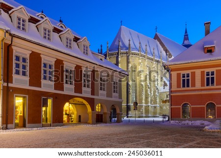 Night view over Brasov\'s most important landmark, the Black Church, the largest Gothic church between Vienna and Istanbul, towers over Piata Sfatului and the old town. Winter time with snow