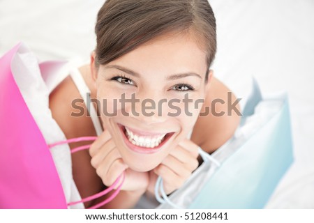 Beautiful shopping woman happy holding shopping bags.