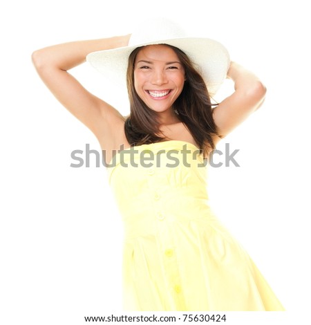 Woman smiling in summer dress playful and cheerful. Isolated on white background. Beautiful cheerful young mixed race ethnic female model in yellow dress and summer hat.
