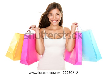 Shopping woman happy smiling holding shopping bags isolated on white background. Lovely fresh young mixed race Asian Caucasian female model.