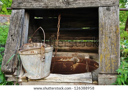 old wooden well with broken bucket
