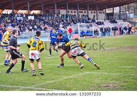 TURIN - MARCH 9: Unidentified player of the Cus Torino team runs toward the goal line during the second Derby della Mole between Cus Torino and Rugby Torino, on March 9, 2013 Turin, Italy.