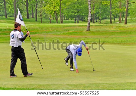 TURIN - MAY 8: BMW Italian Open. Matteo Manassero takes the ball into the hole number one during round three. May 6-9, 2010 Royal Park I Roveri Turin, Italy.