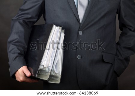 Businessman carrying file folders