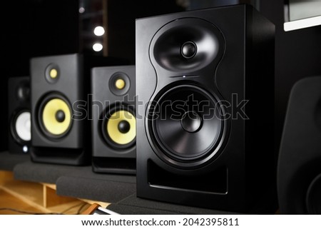 Buy new speakers. Professional studio monitors in music store. High fidelity speaker for hifi sound system, musician or sound recording studio.