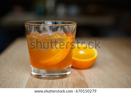 Enjoy refreshing tequila sunrise long drink in bar.Juicy cocktails for party.Crystal glass with orange juice booze.Hot drink for adults.Delicious refreshing orange cocktail with rum.Alcoholic drinks