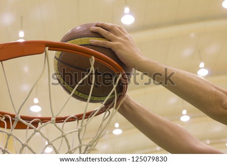 scoring basket in basketball court