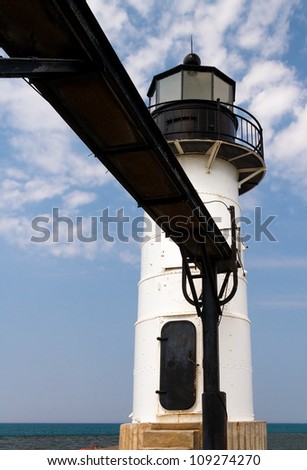 White lighthouse with elevated catwalk approach on North Pier at St. Joseph, Michigan, Lake Michigan