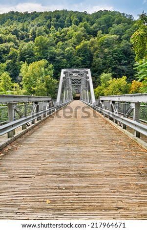 The Fayette Station Bridge, with its wooden deck, crosses West Virginia\'s New River in Fayette County. The span is also called the Tunney Hunsaker Bridge.