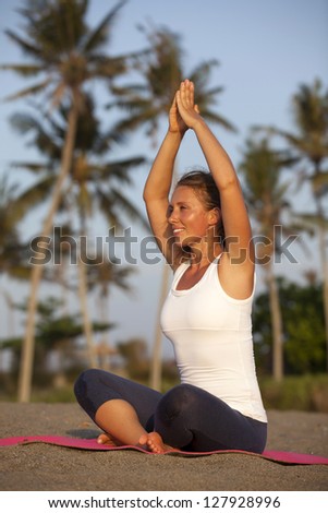 Healthy happy woman doing yoga on mat